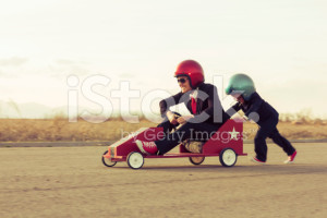 stock-photo-54278840-young-boy-with-businesswoman-racing-a-toy-car