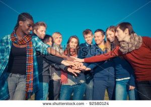 stock-photo-happy-college-students-with-hands-on-stack-92580124